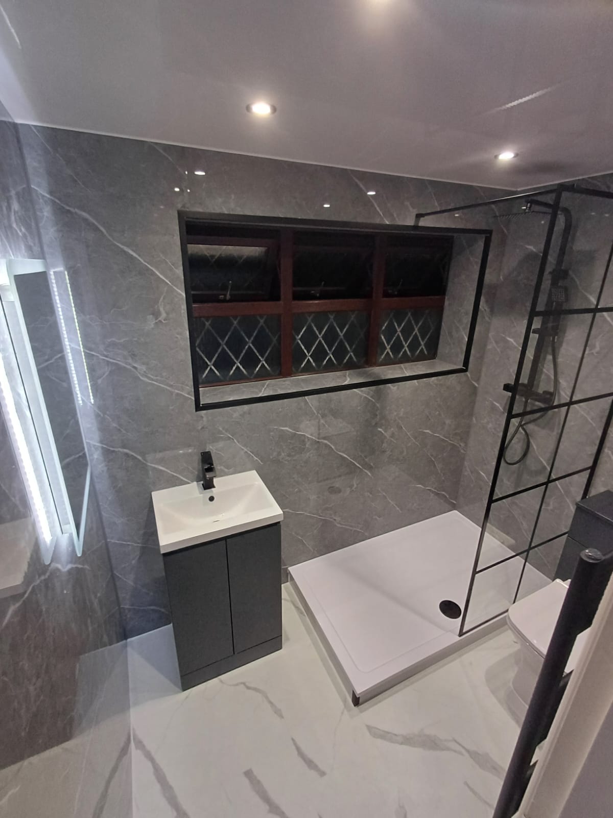 Finished bathroom using Dark Grey Marble Gloss panels